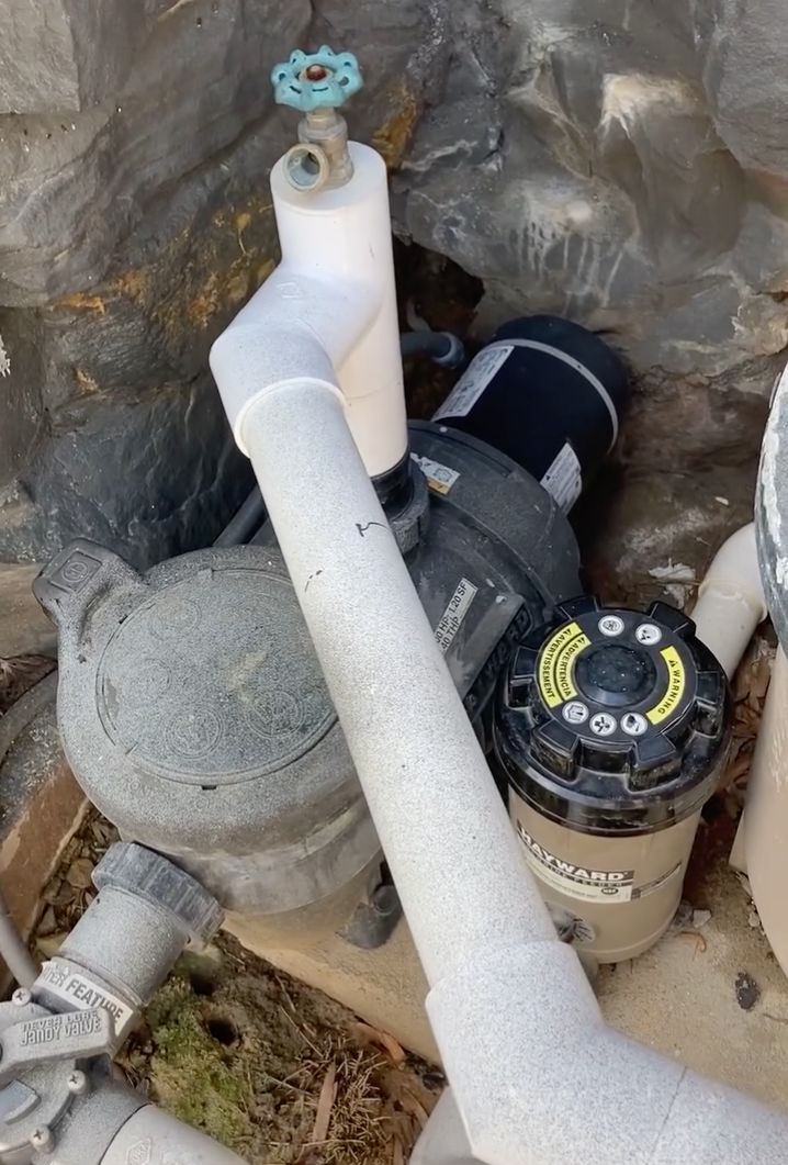 Pool pump and cartridge filter with white PVC plumbing